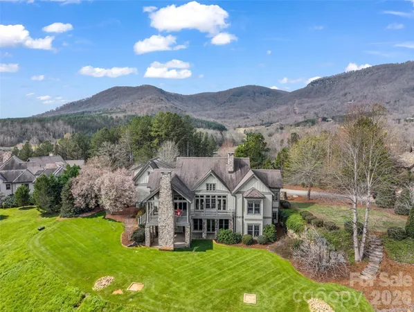 a living room with furniture fireplace and a large window