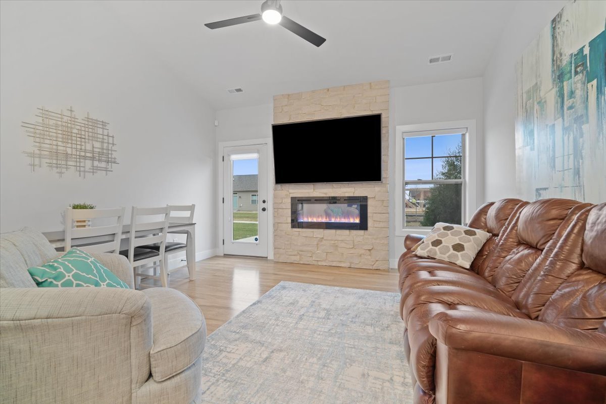1911 Glenbridge Road Bloomington, IL 61704 - Photo 11 of 36 a living room with furniture a flat screen tv and a fireplace