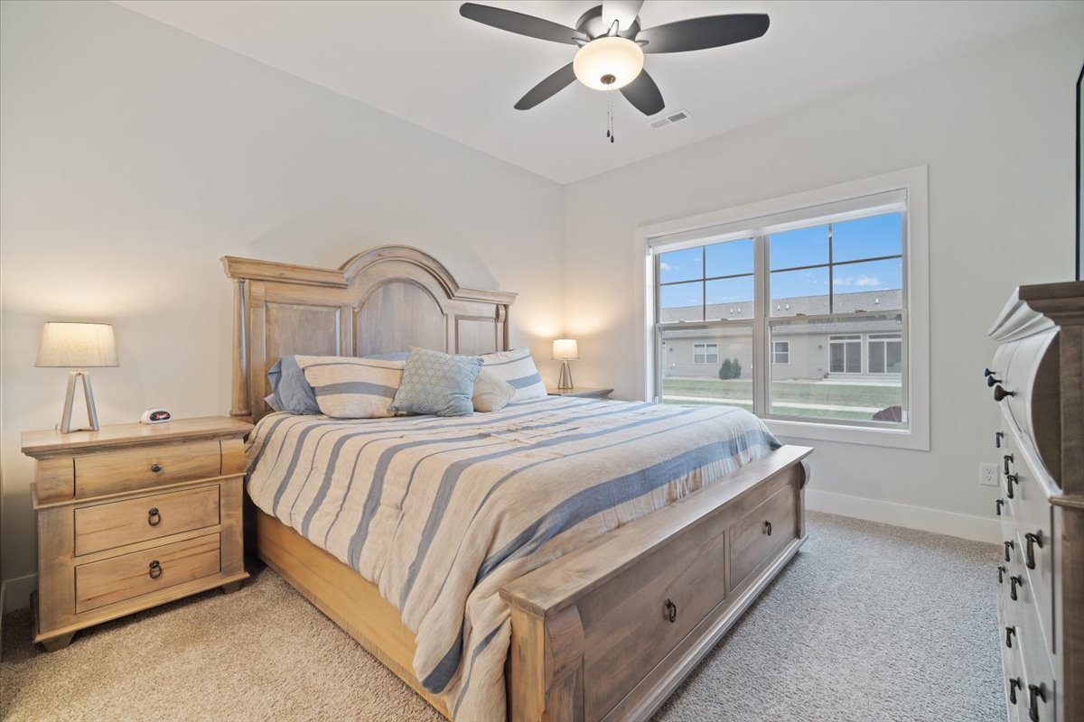 1911 Glenbridge Road Bloomington, IL 61704 - Photo 14 of 36 a bedroom with a bed and a chandelier