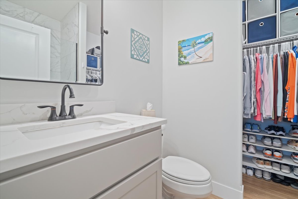 1911 Glenbridge Road Bloomington, IL 61704 - Photo 16 of 36 a bathroom with a sink a toilet and a mirror