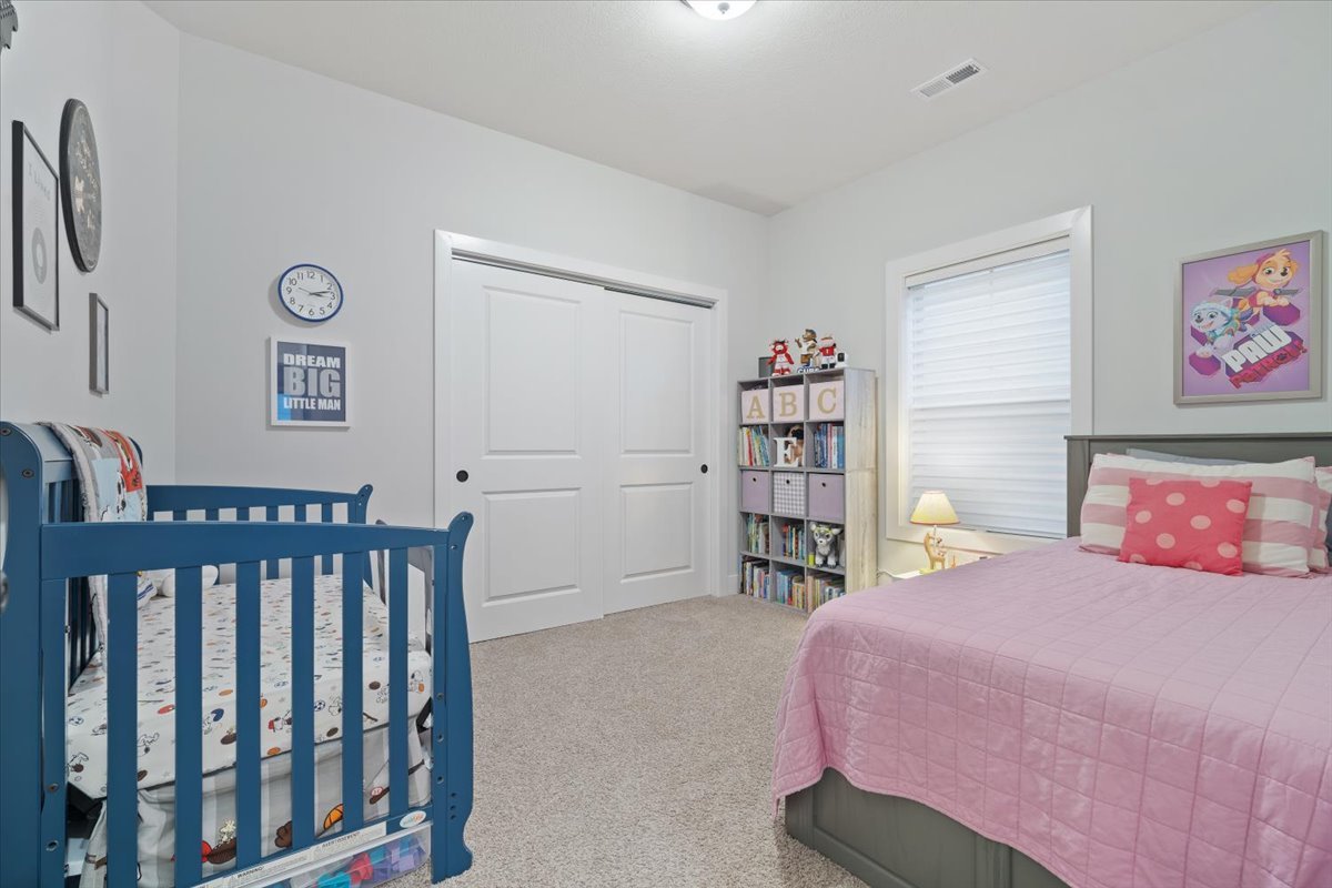 1911 Glenbridge Road Bloomington, IL 61704 - Photo 17 of 36 a bedroom with a bed and a book shelf