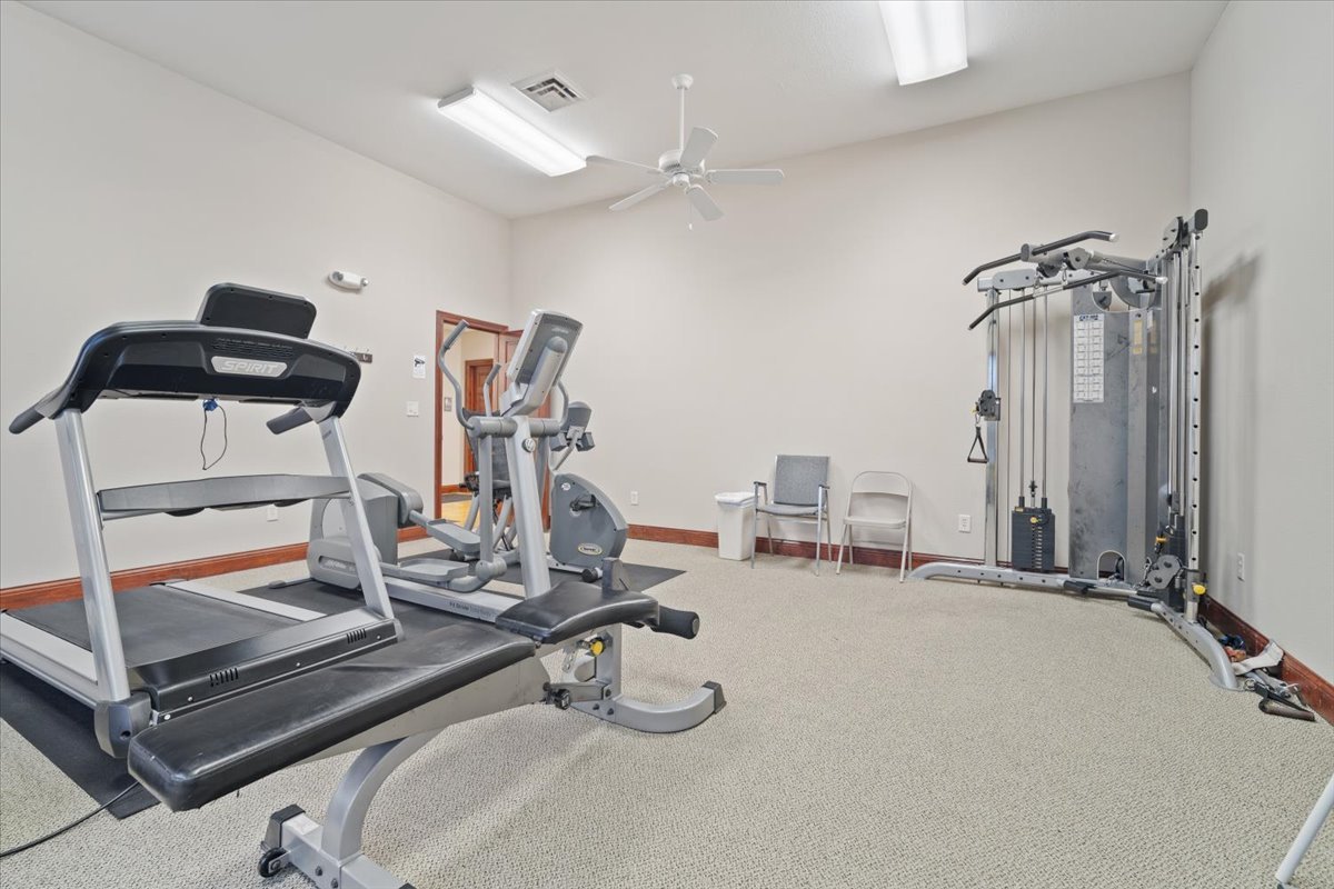 1911 Glenbridge Road Bloomington, IL 61704 - Photo 33 of 36 a room with gym equipment and mirror