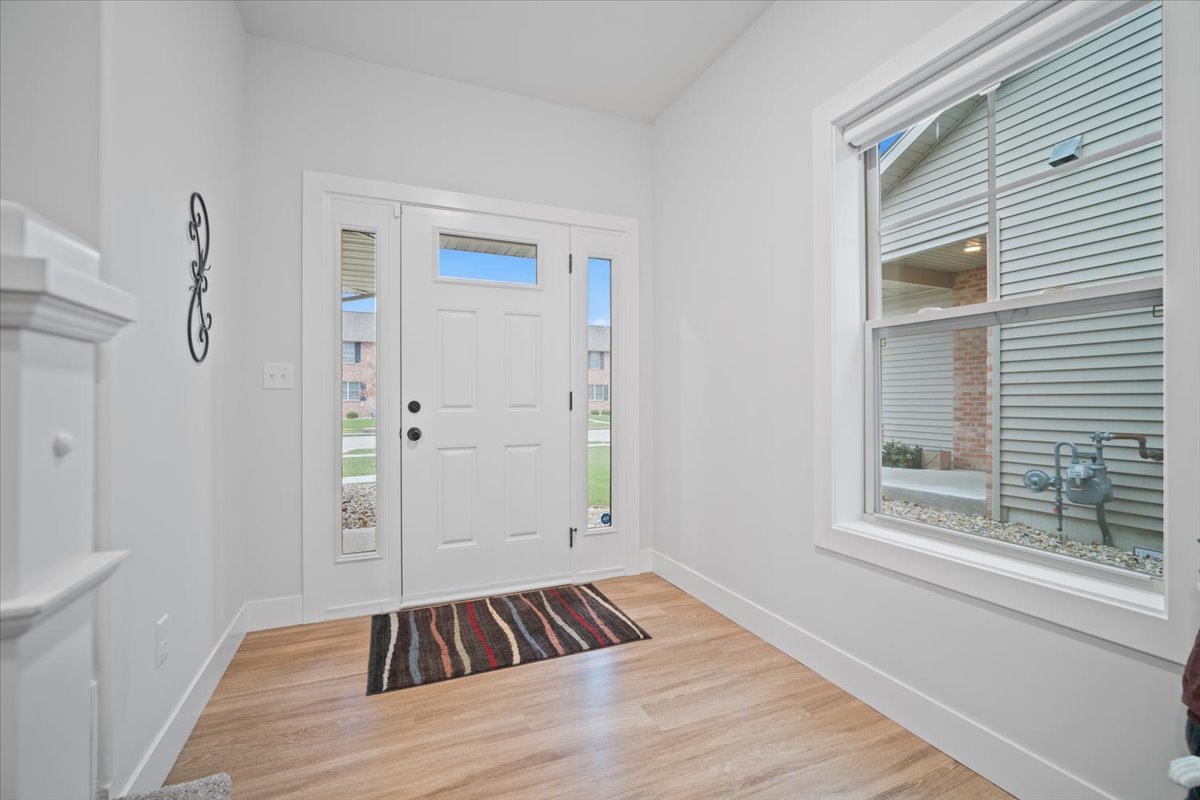 1911 Glenbridge Road Bloomington, IL 61704 - Photo 4 of 36 a view of an empty room with wooden floor and a window