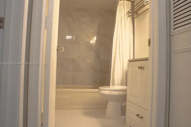 a bathroom with a granite countertop shower and a sink