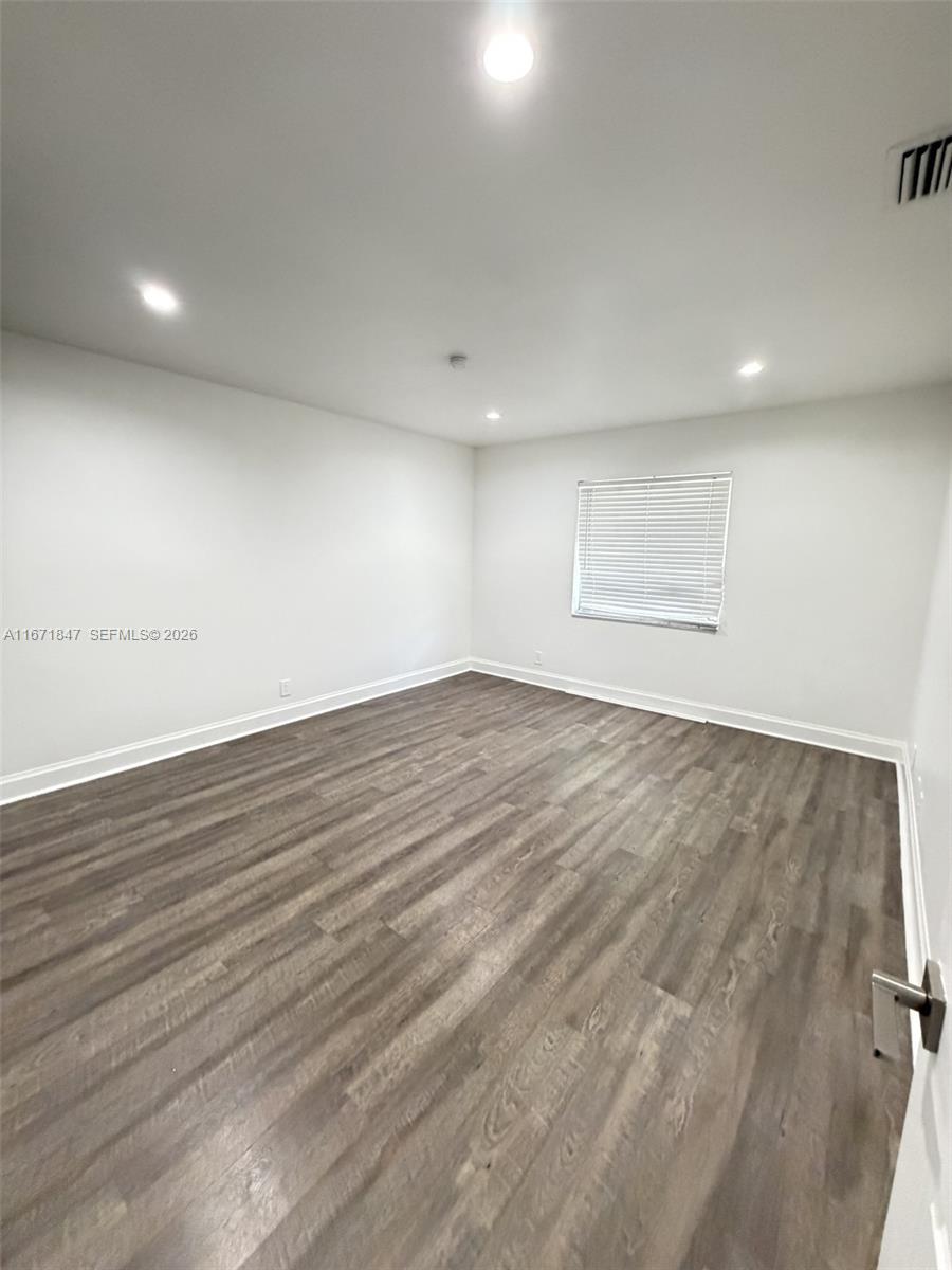 20927 Sedgewick Drive Boca Raton, FL 33433 - Photo 17 of 24 an empty room with wooden floor and windows