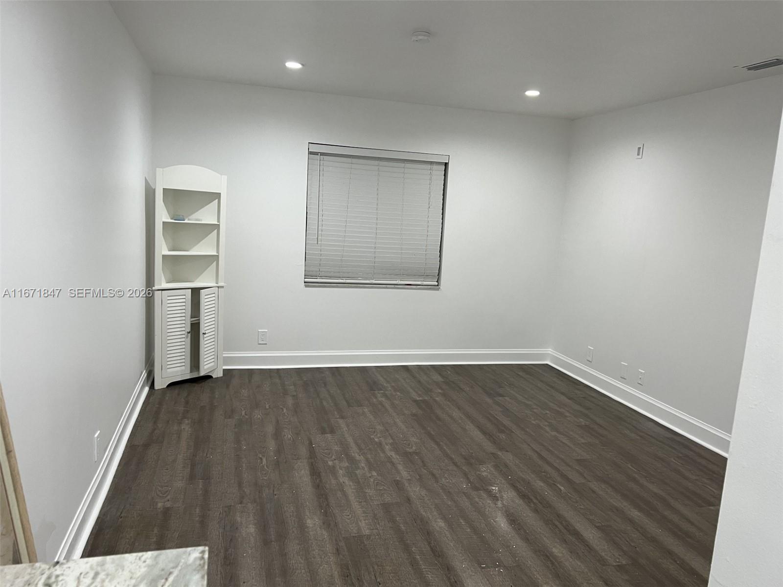 20927 Sedgewick Drive Boca Raton, FL 33433 - Photo 20 of 24 an empty room with wooden floor and windows