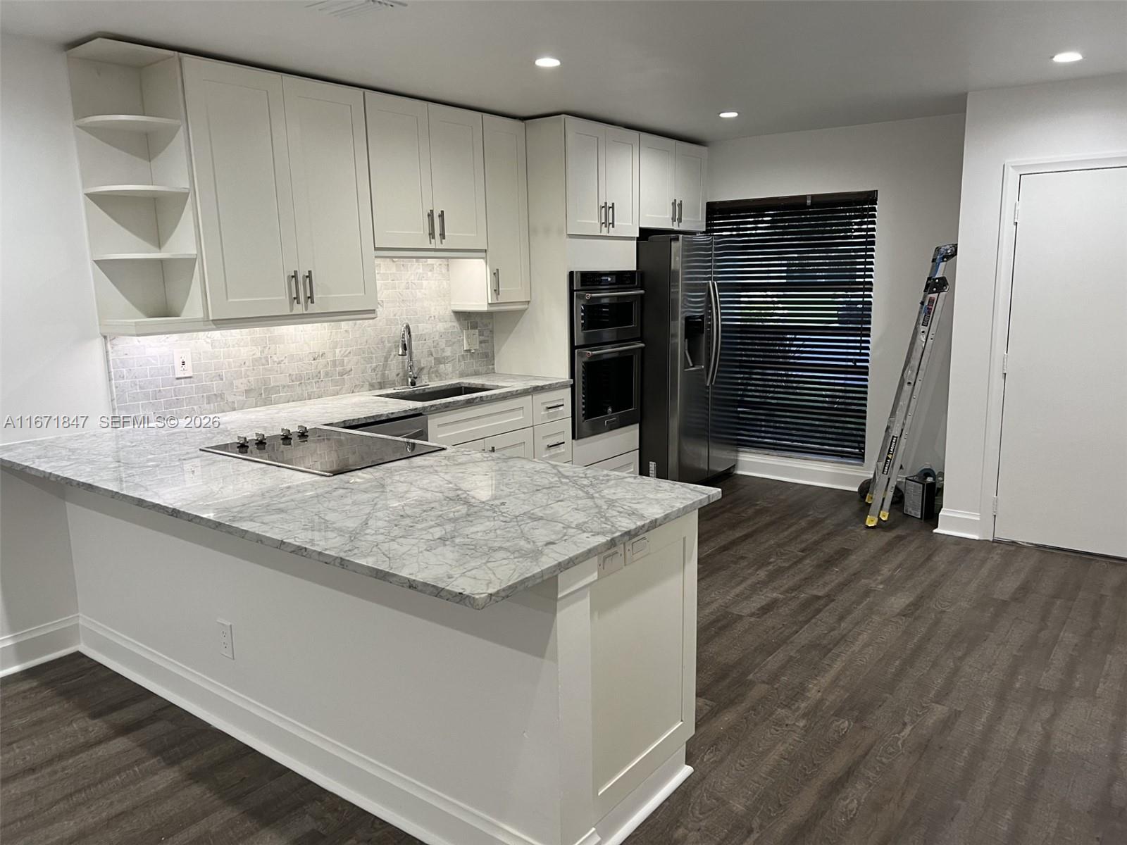 20927 Sedgewick Drive Boca Raton, FL 33433 - Photo 10 of 24 a kitchen with stainless steel appliances granite countertop a sink refrigerator and cabinets