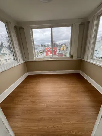 a view of lot of room with window and hardwood floor