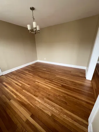a view of a livingroom with a ceiling fan and wooden floor