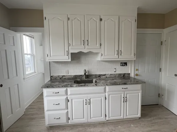 a kitchen with stainless steel appliances granite countertop a sink and cabinets