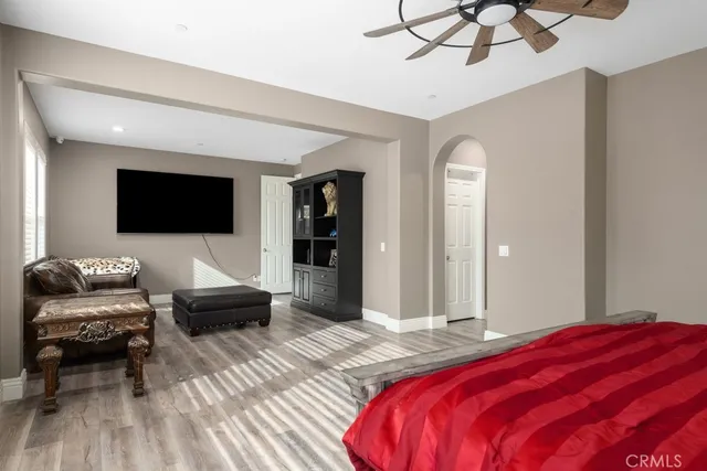 a bedroom with a bed and a flat screen tv