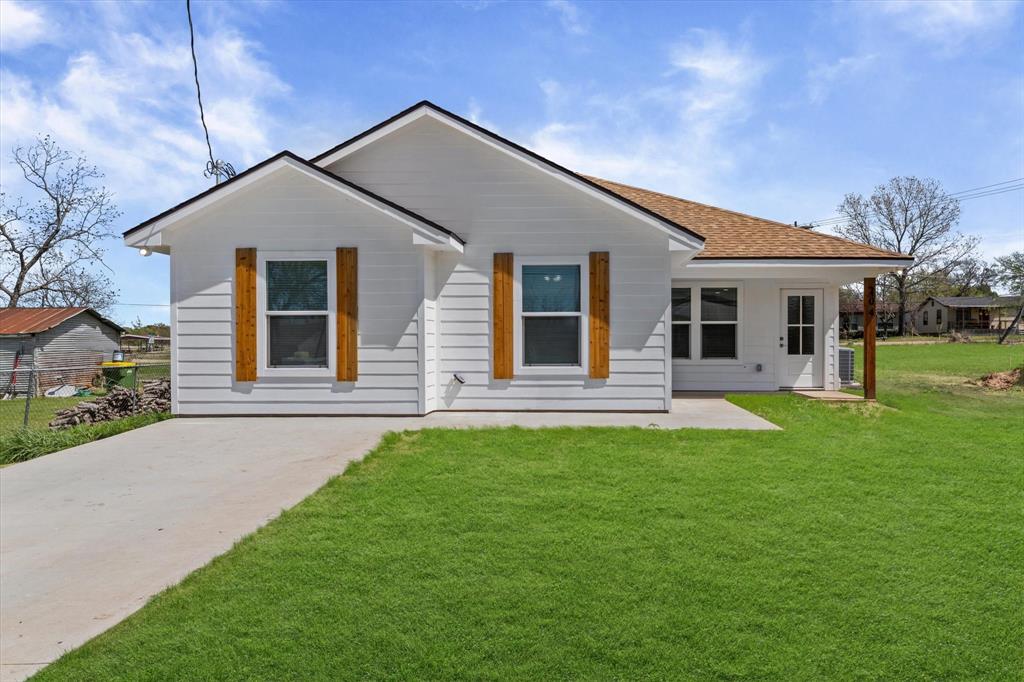 a front view of house with yard and green space