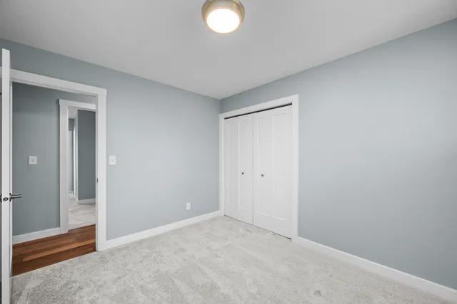 an empty room with closet area