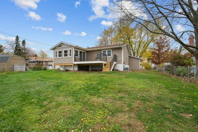 a view of a house with a big yard and large trees