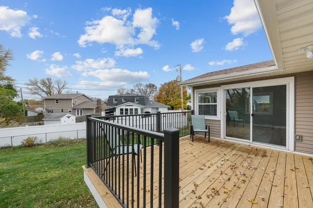 a view of a roof deck with wooden fence and a floor to ceiling window
