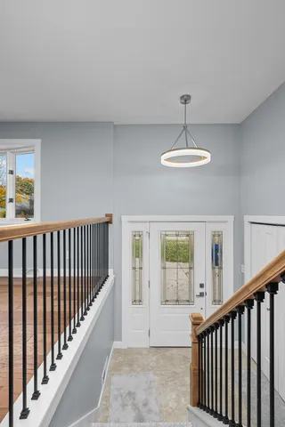 a view of a balcony with wooden floor and chandelier
