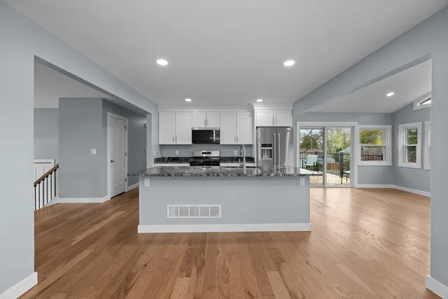 a view of kitchen with cabinets and wooden floor