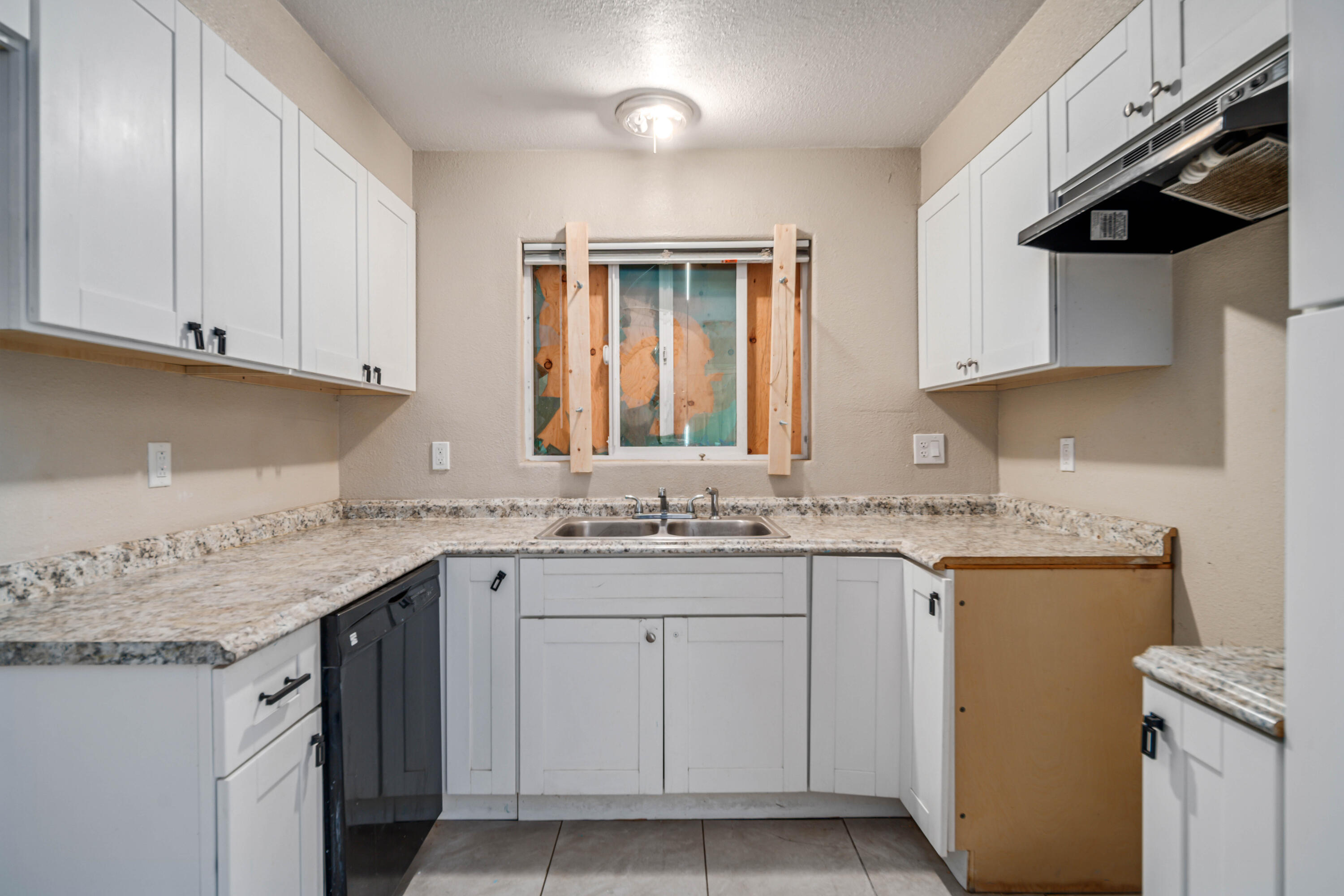 621 Ave J E Lancaster Ca East Lancaster, CA 93535 - Photo 11 of 25 a kitchen with a sink stove and cabinets