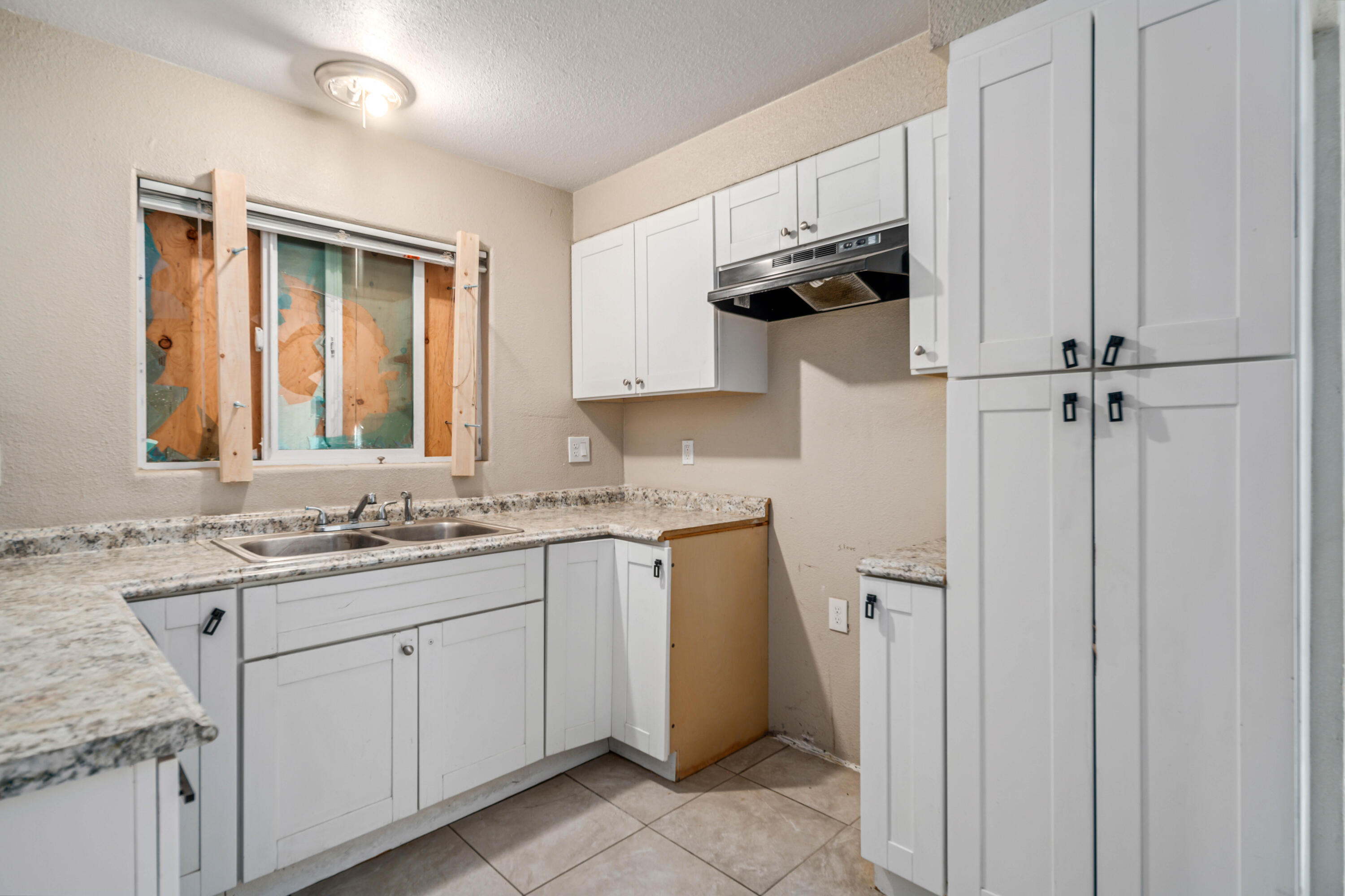 621 Ave J E Lancaster Ca East Lancaster, CA 93535 - Photo 12 of 25 a kitchen with a sink cabinets and appliances