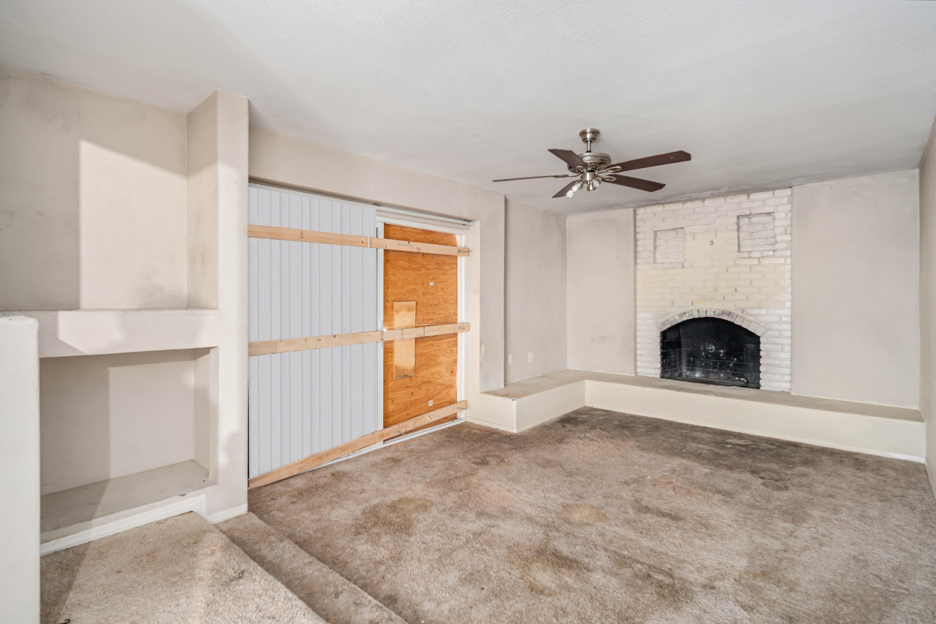 621 Ave J E Lancaster Ca East Lancaster, CA 93535 - Photo 13 of 25 an empty room with fireplace and windows