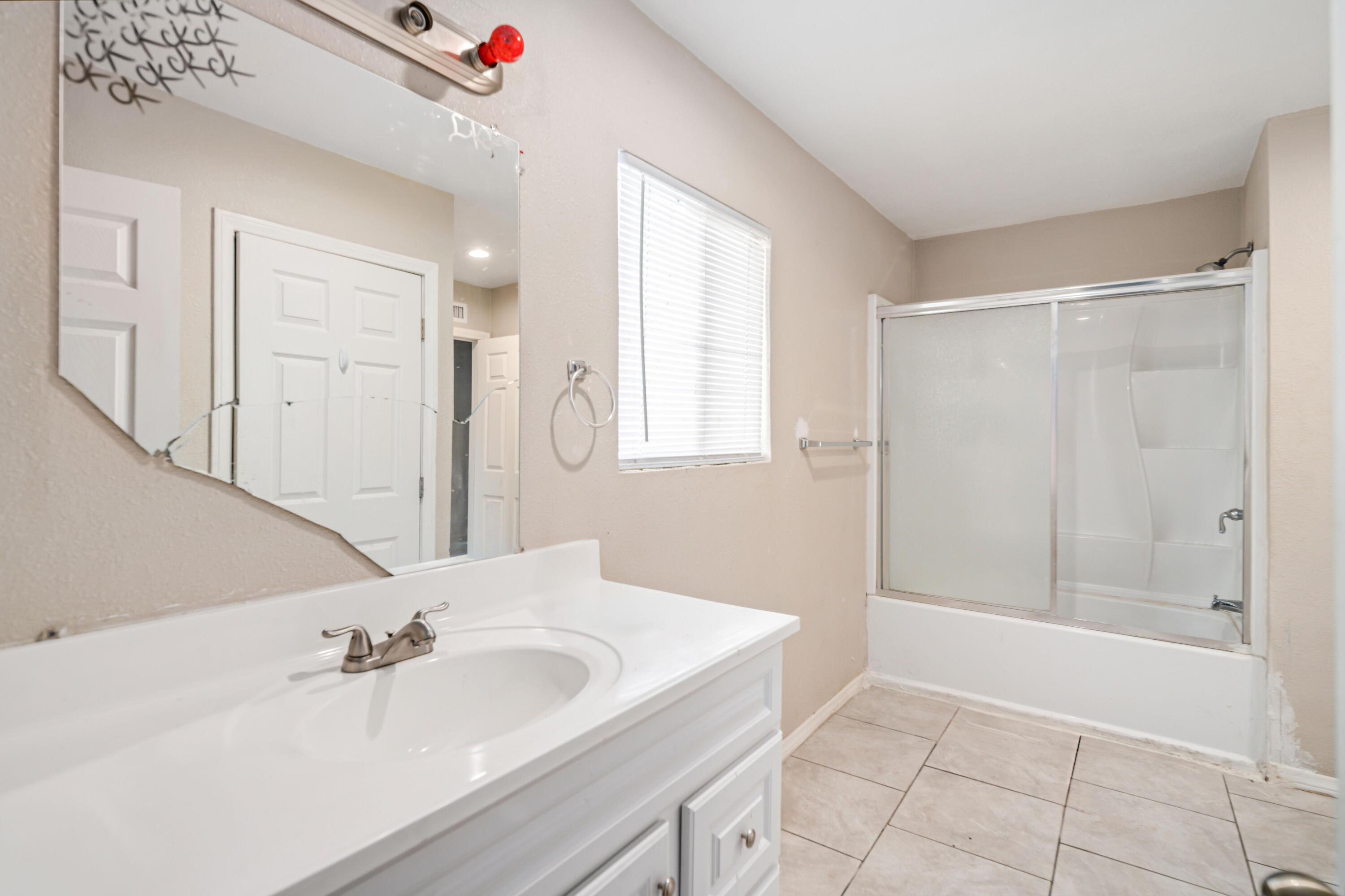 621 Ave J E Lancaster Ca East Lancaster, CA 93535 - Photo 17 of 25 a bathroom with a sink and a mirror