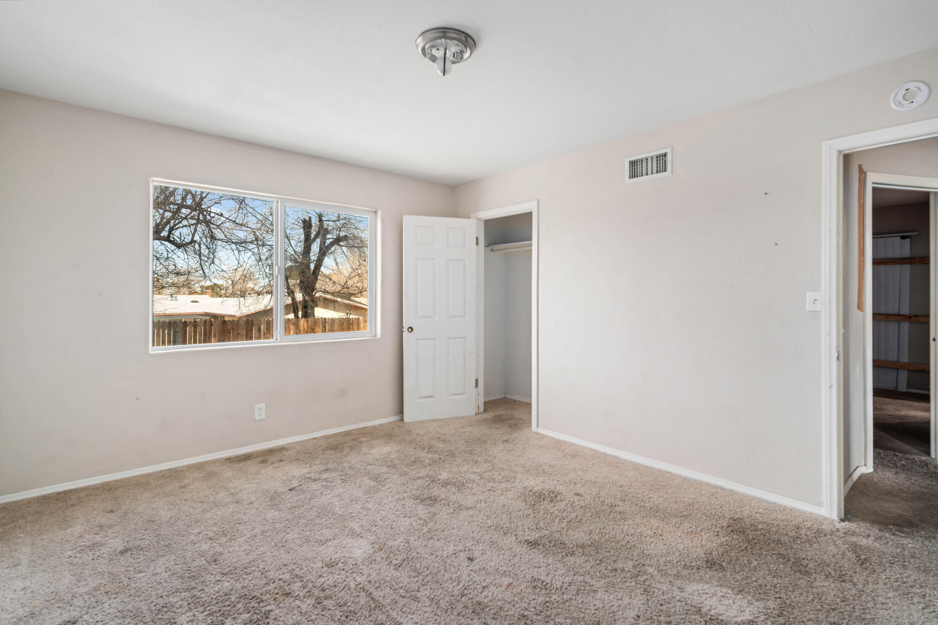 621 Ave J E Lancaster Ca East Lancaster, CA 93535 - Photo 20 of 25 an empty room with windows and closet