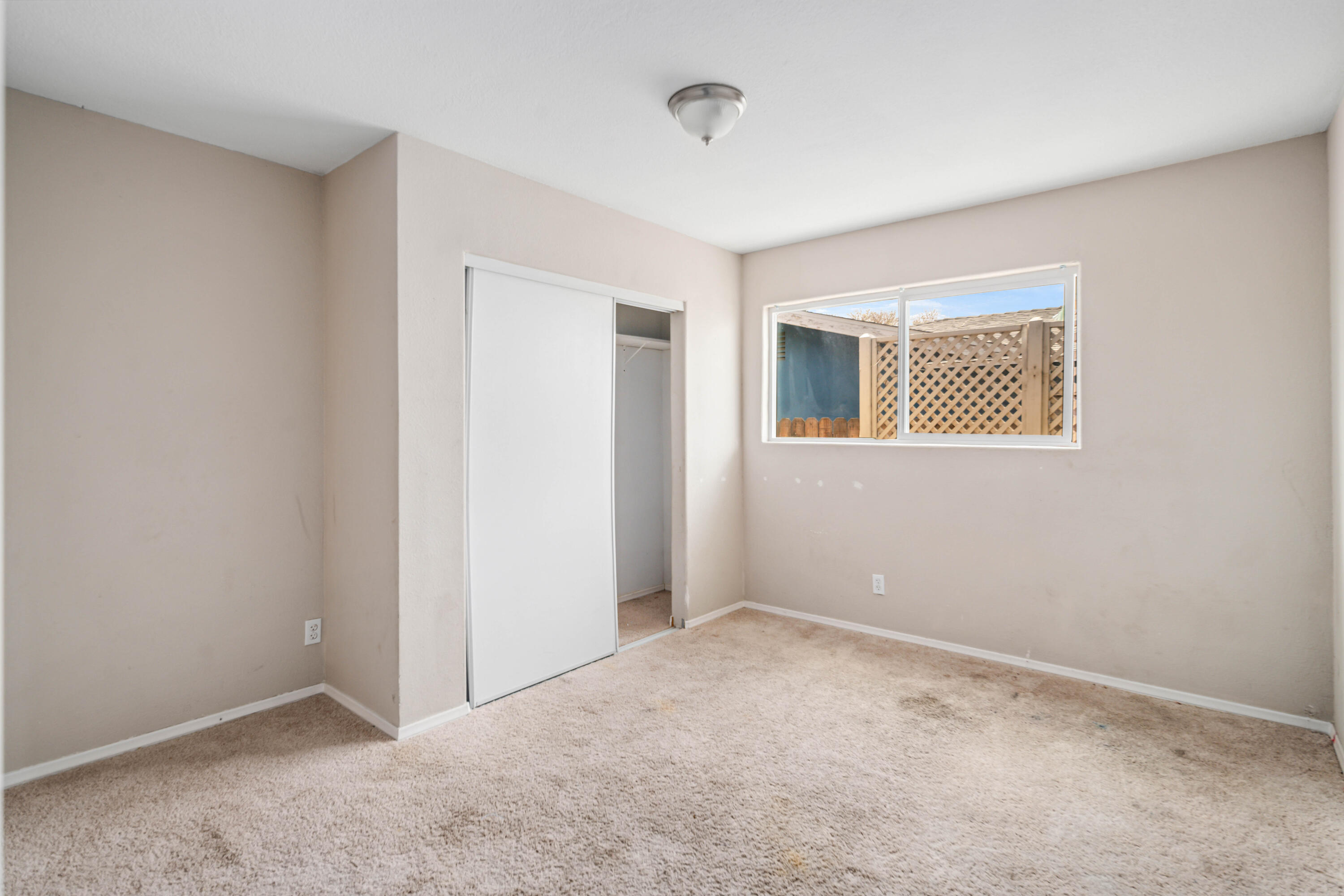 621 Ave J E Lancaster Ca East Lancaster, CA 93535 - Photo 21 of 25 a view of an empty room with closet and a window