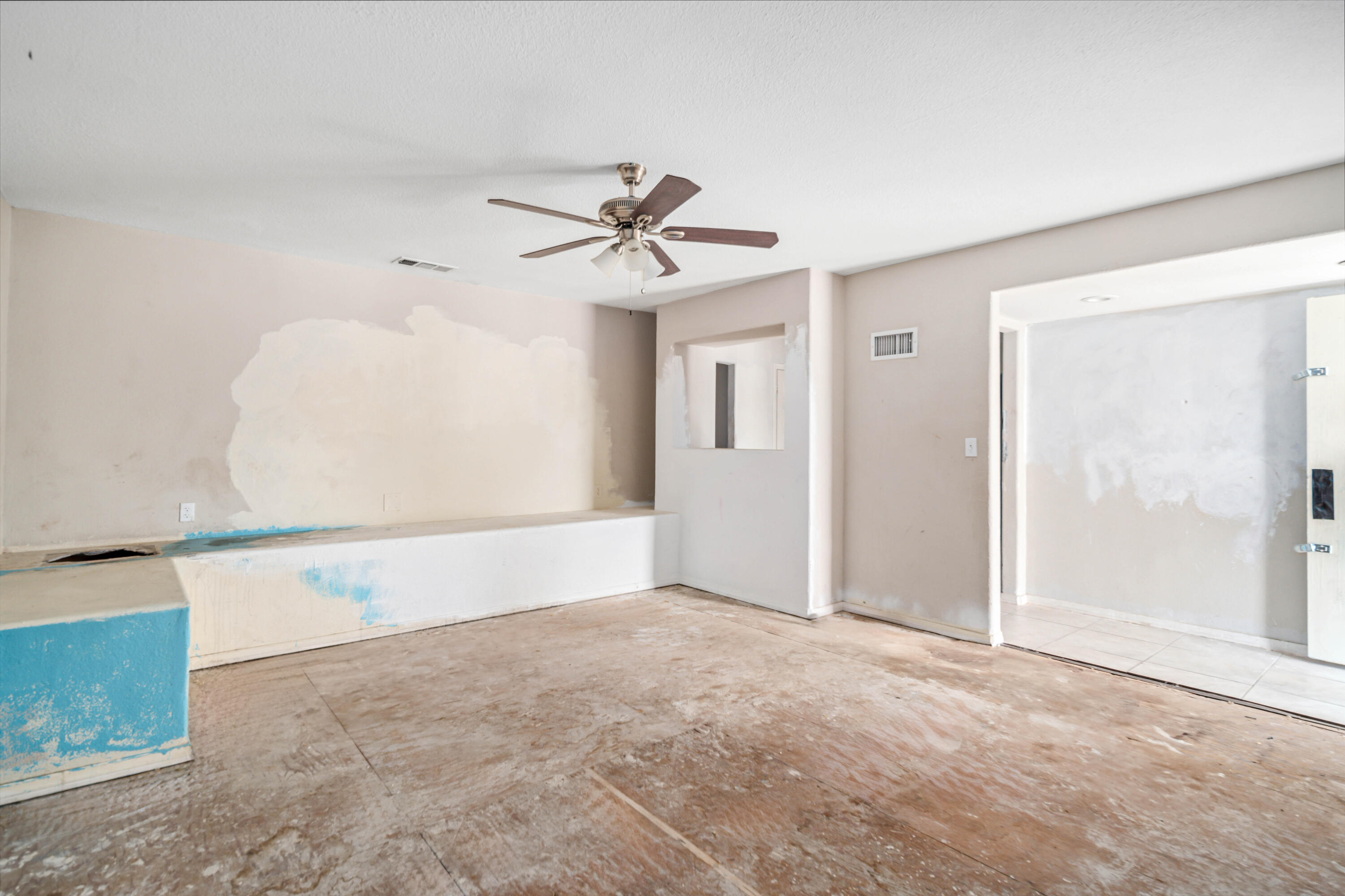 621 Ave J E Lancaster Ca East Lancaster, CA 93535 - Photo 8 of 25 an empty room with windows and fan