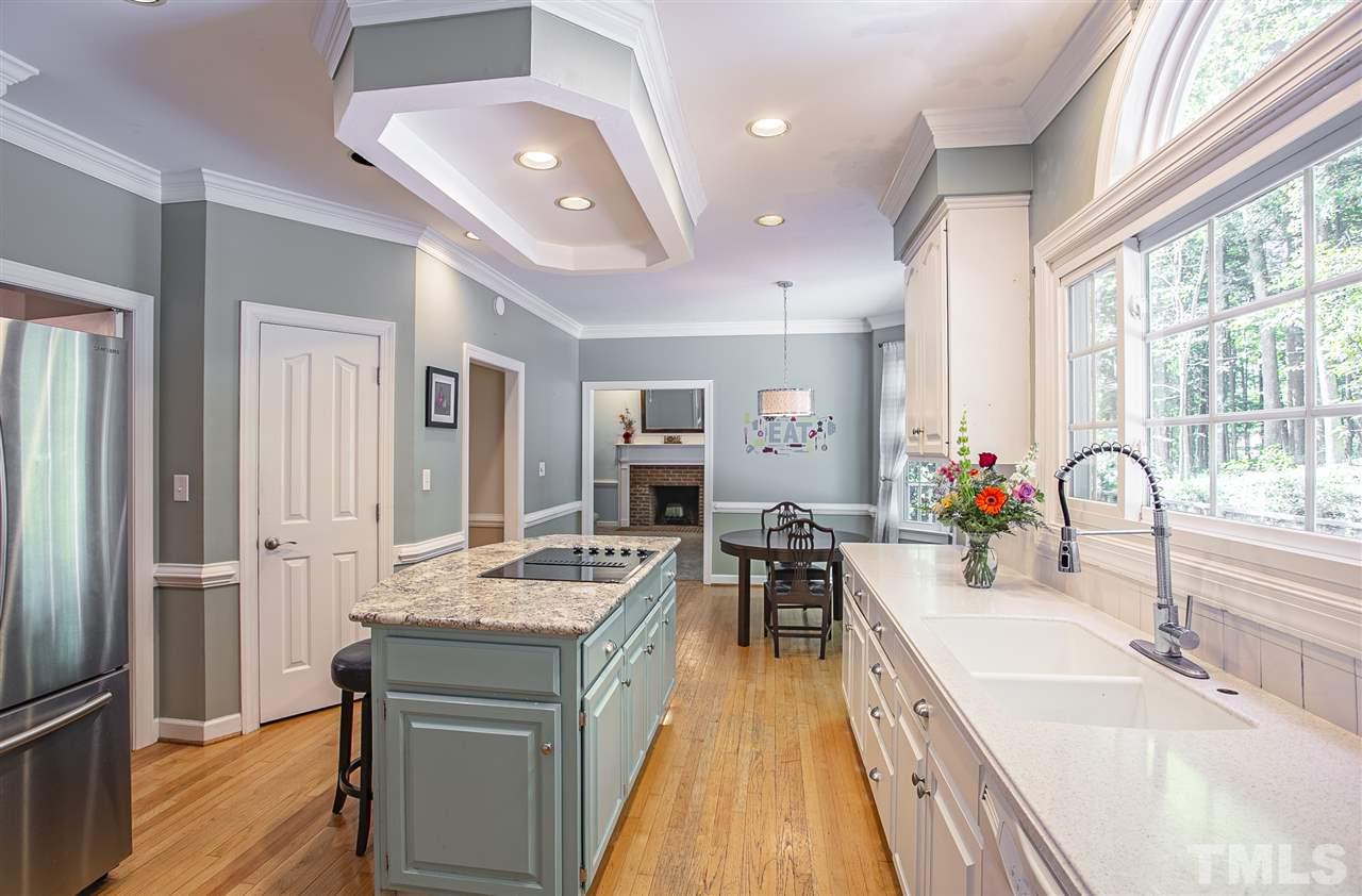 11503 South Lowell Road Bahama, NC 27503 - Photo 4 of 30 Granite countertops are a wonderful update to this spacious kitchen with walk-in pantry.