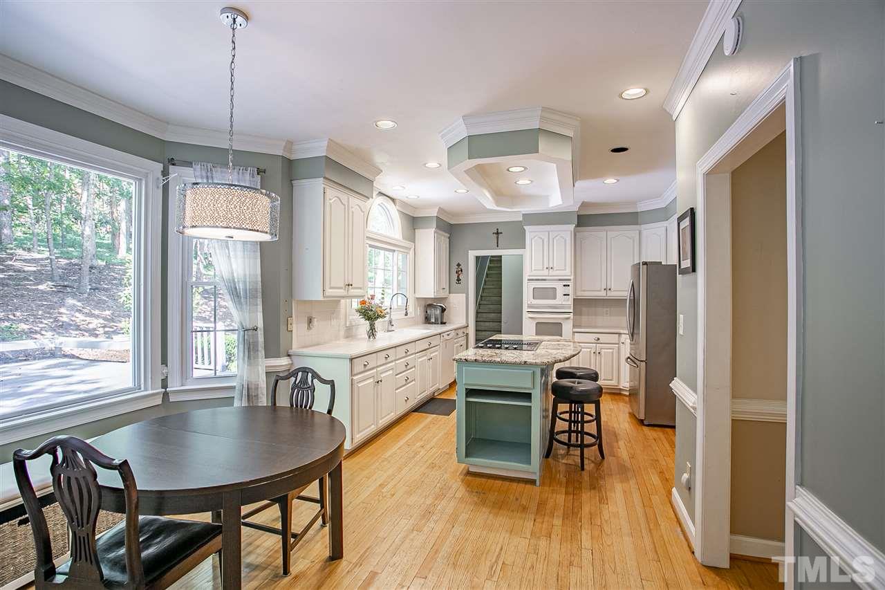11503 South Lowell Road Bahama, NC 27503 - Photo 6 of 30 Hardwood floors throughout kitchen space; plenty of cabinets and storage!