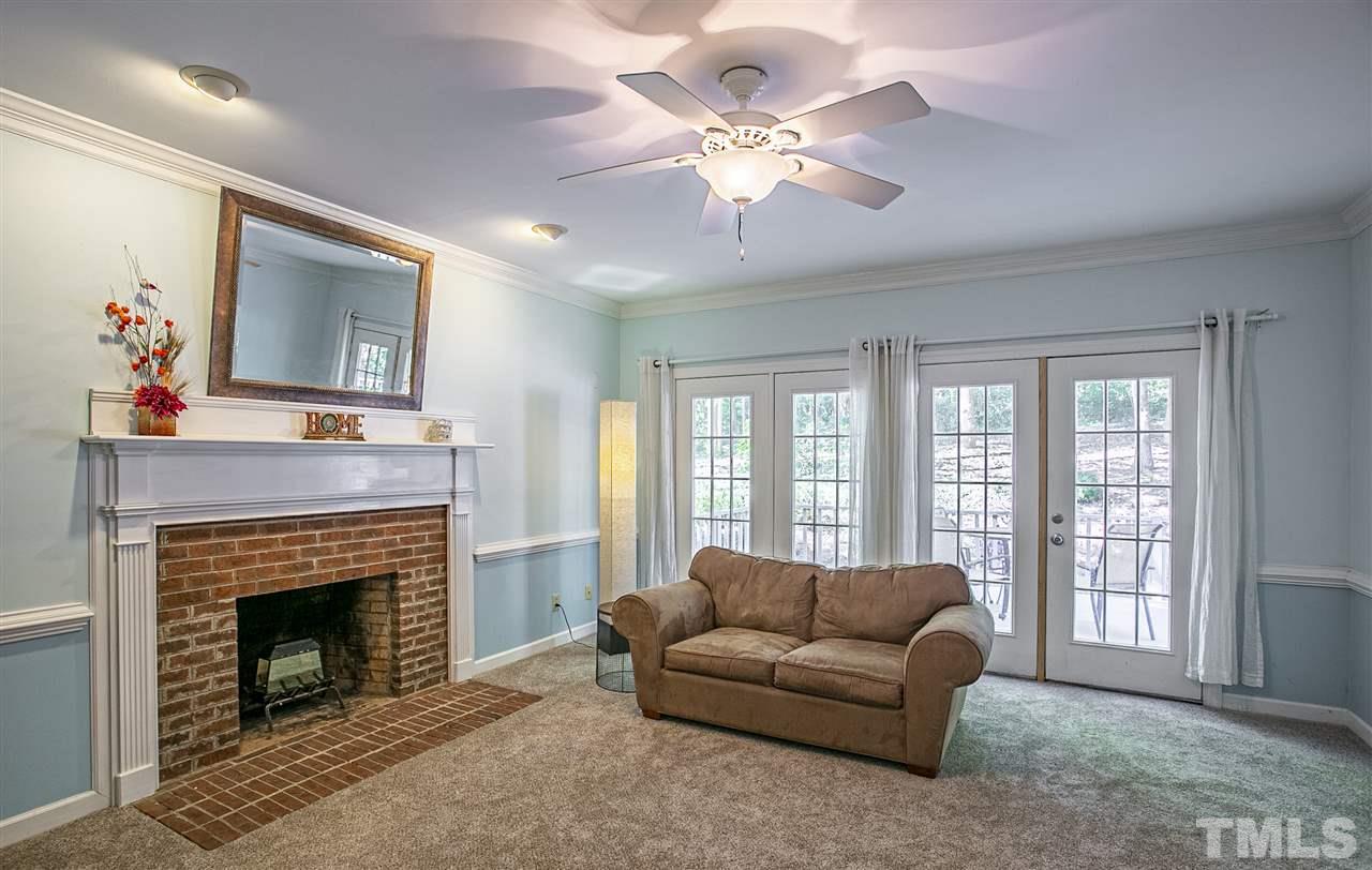 11503 South Lowell Road Bahama, NC 27503 - Photo 9 of 30 Masonry, wood-burning fireplace AND new carpet AND views of the backyard make this a COZY space to relax and enjoy family!