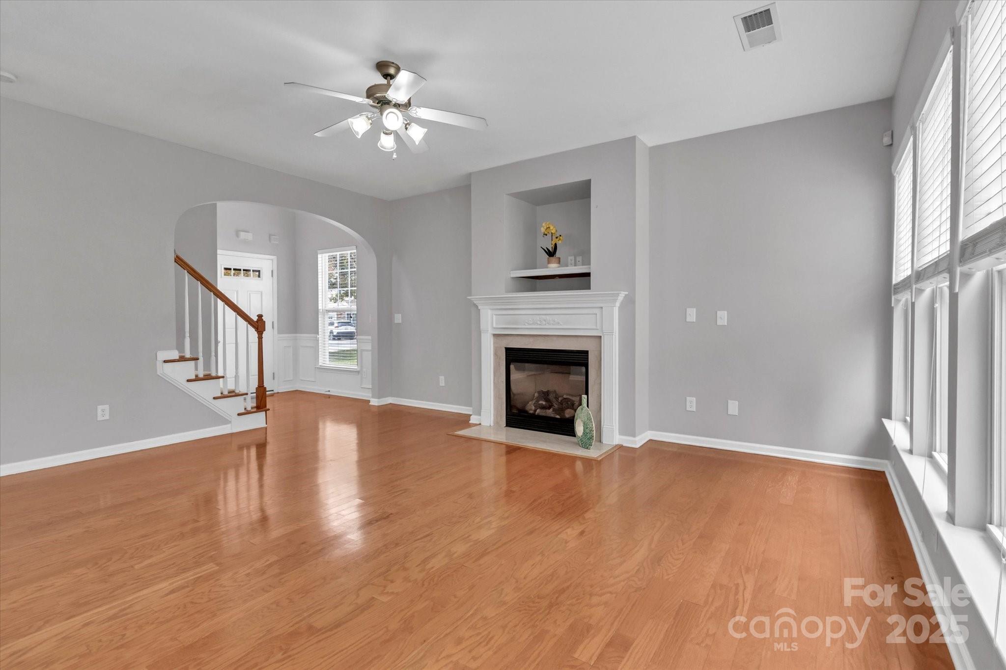 297 Sand Paver Way Fort Mill, SC 29708 - Photo 11 of 39 an empty room with wooden floor fireplace and windows