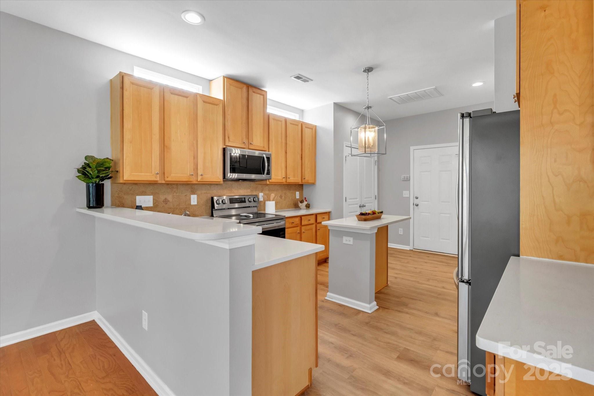 297 Sand Paver Way Fort Mill, SC 29708 - Photo 15 of 39 a kitchen with stainless steel appliances granite countertop a sink stove and refrigerator