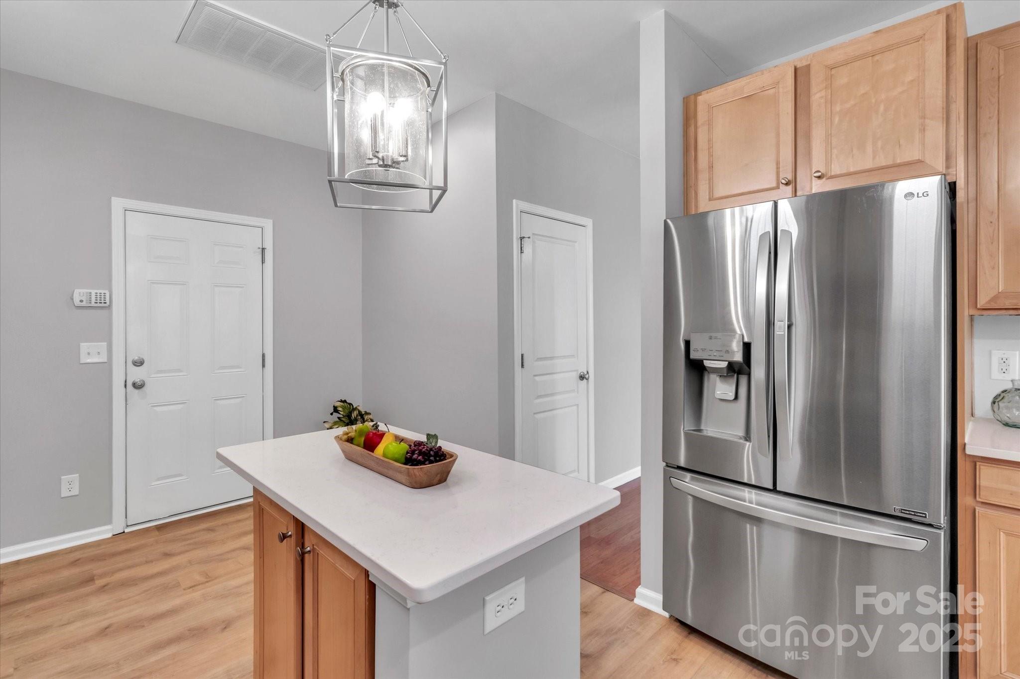 297 Sand Paver Way Fort Mill, SC 29708 - Photo 18 of 39 a kitchen with stainless steel appliances a refrigerator and wooden floor