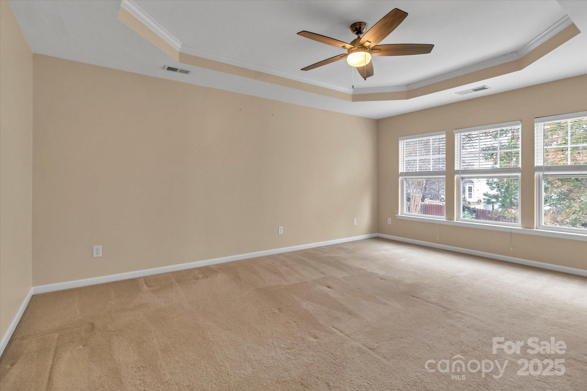 297 Sand Paver Way Fort Mill, SC 29708 - Photo 23 of 39 an empty room with windows and ceiling fan