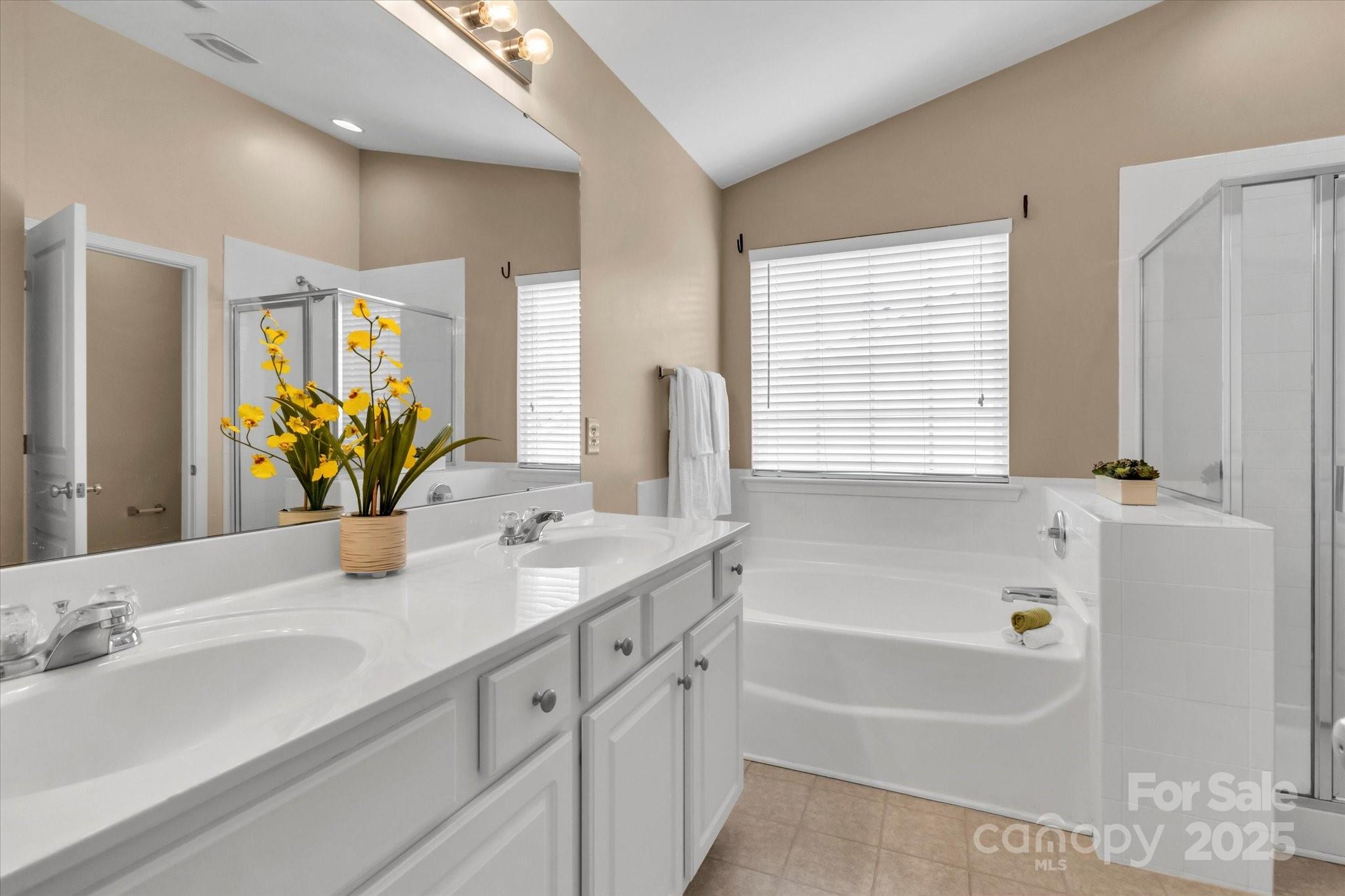 297 Sand Paver Way Fort Mill, SC 29708 - Photo 26 of 39 a bathroom with a tub sink and mirror