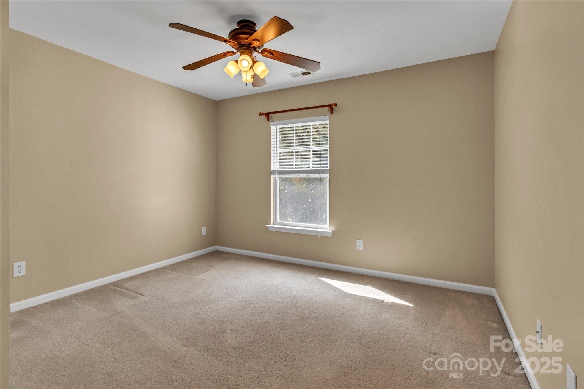 297 Sand Paver Way Fort Mill, SC 29708 - Photo 28 of 39 an empty room with a window and a fan