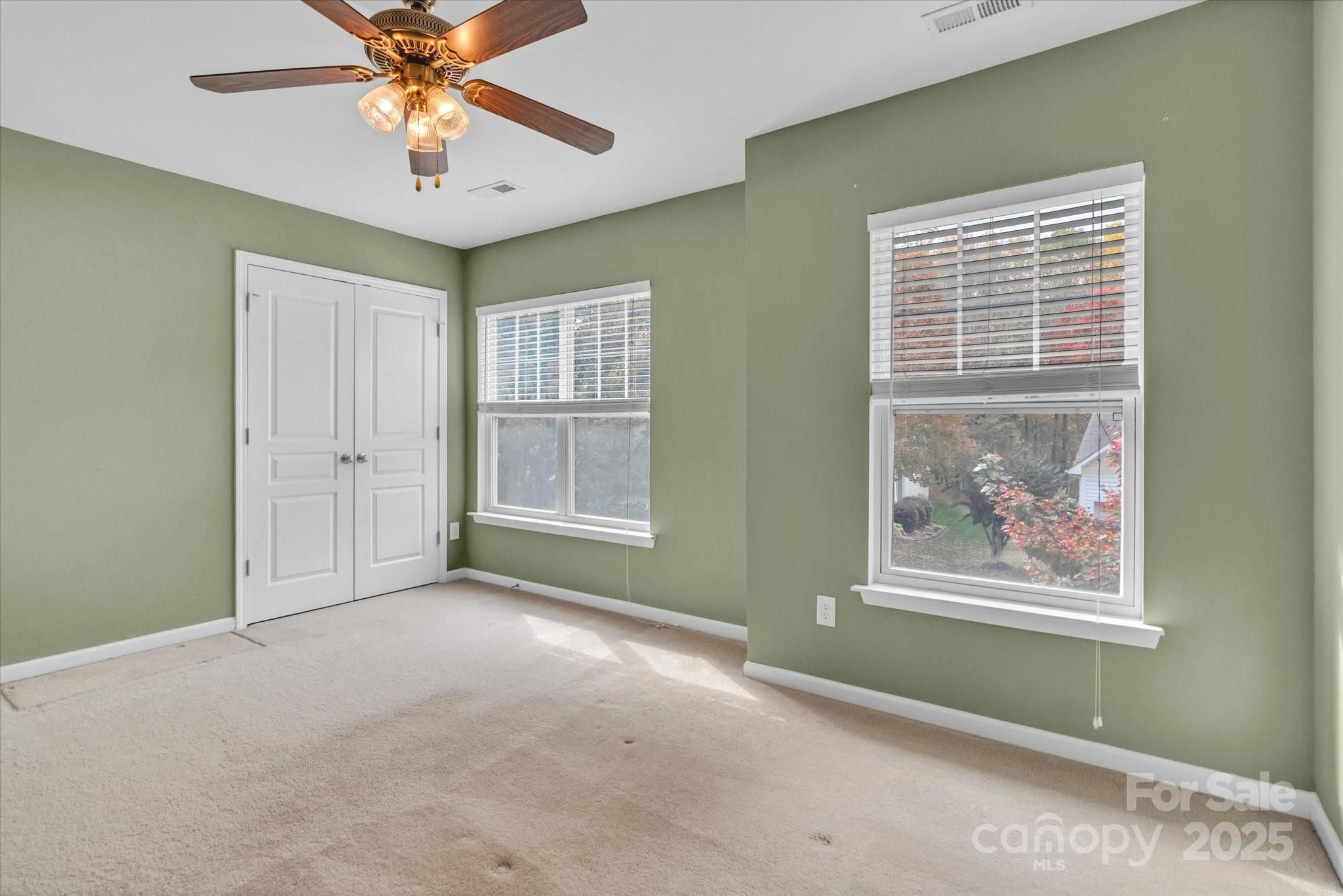 297 Sand Paver Way Fort Mill, SC 29708 - Photo 31 of 39 an empty room with windows and fan