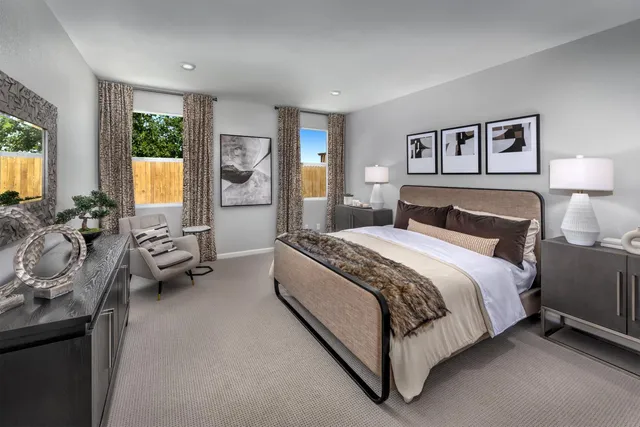 a spacious bedroom with a bed and glass windows