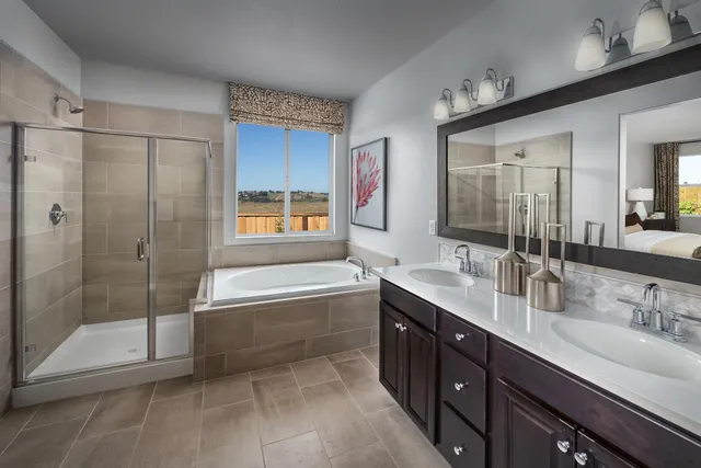 a bathroom with a tub sink shower and mirror