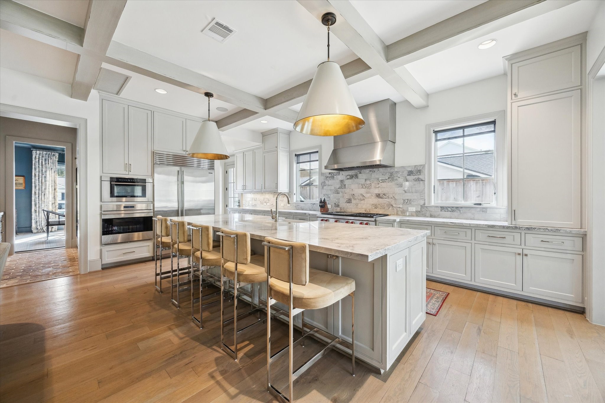 6218 Burgoyne Road Houston, TX 77057 - Photo 16 of 43 a kitchen with kitchen island granite countertop a table chairs sink and cabinets
