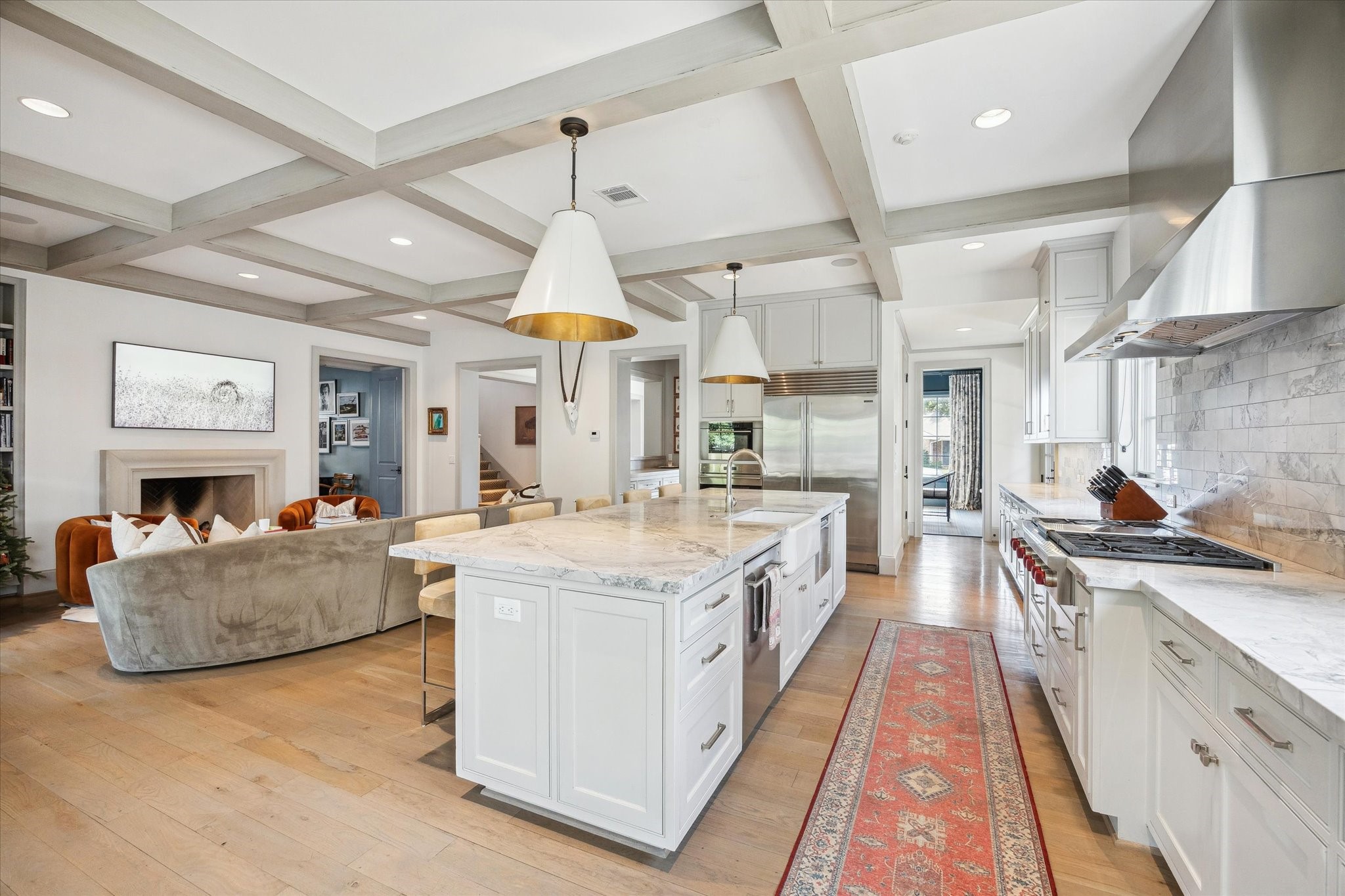 6218 Burgoyne Road Houston, TX 77057 - Photo 18 of 43 a large kitchen with stainless steel appliances kitchen island granite countertop a lot of cabinets and wooden floors