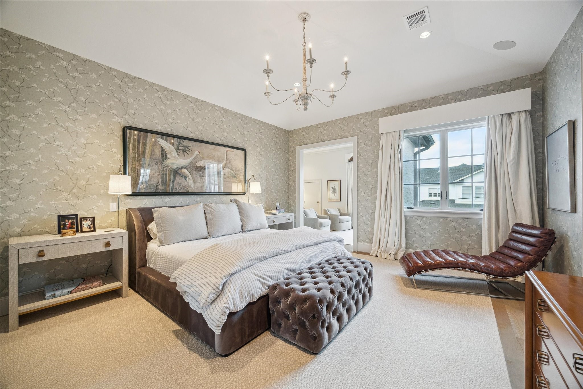 6218 Burgoyne Road Houston, TX 77057 - Photo 26 of 43 a spacious bedroom with a large bed and a chandelier