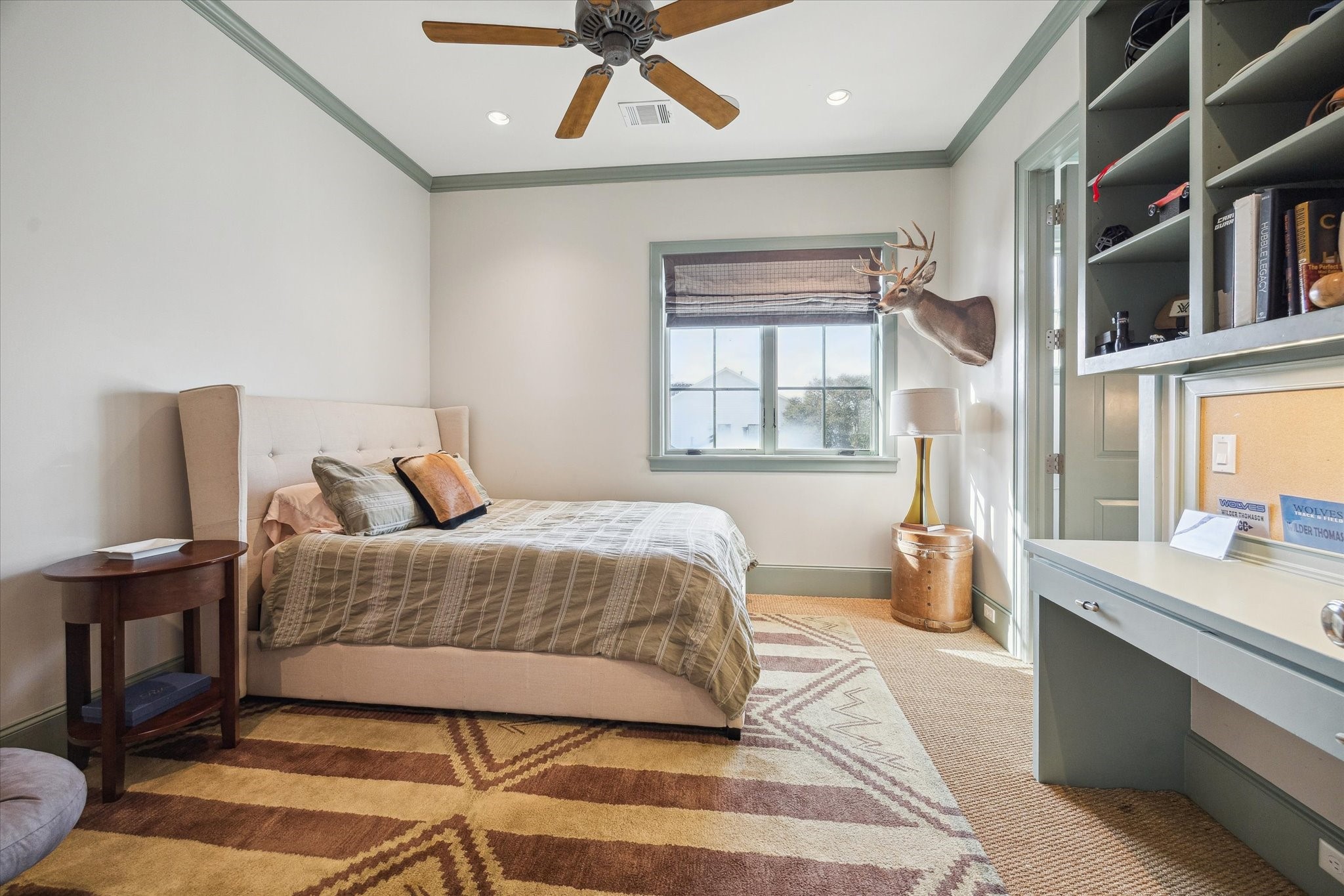 6218 Burgoyne Road Houston, TX 77057 - Photo 36 of 43 a bedroom with a bed a bookshelf and a window