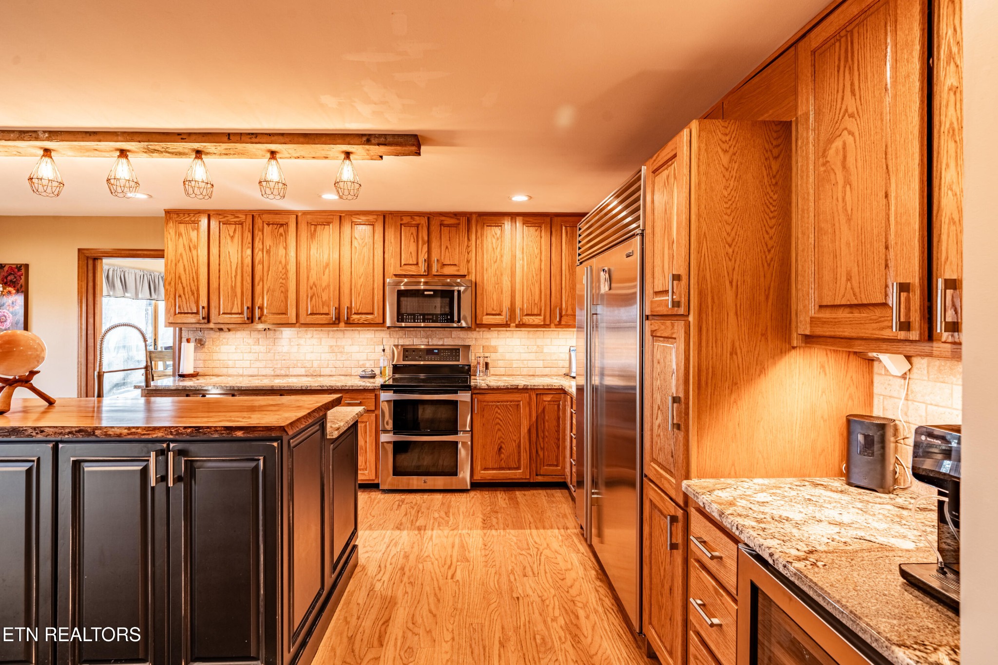 11104 Poplar Ridge Road Knoxville, TN 37932 - Photo 17 of 53 a kitchen with stainless steel appliances granite countertop a stove refrigerator and cabinets
