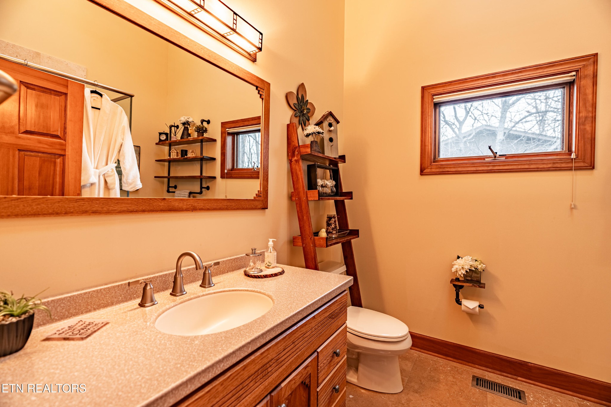 11104 Poplar Ridge Road Knoxville, TN 37932 - Photo 38 of 53 a bathroom with a toilet a sink and mirror