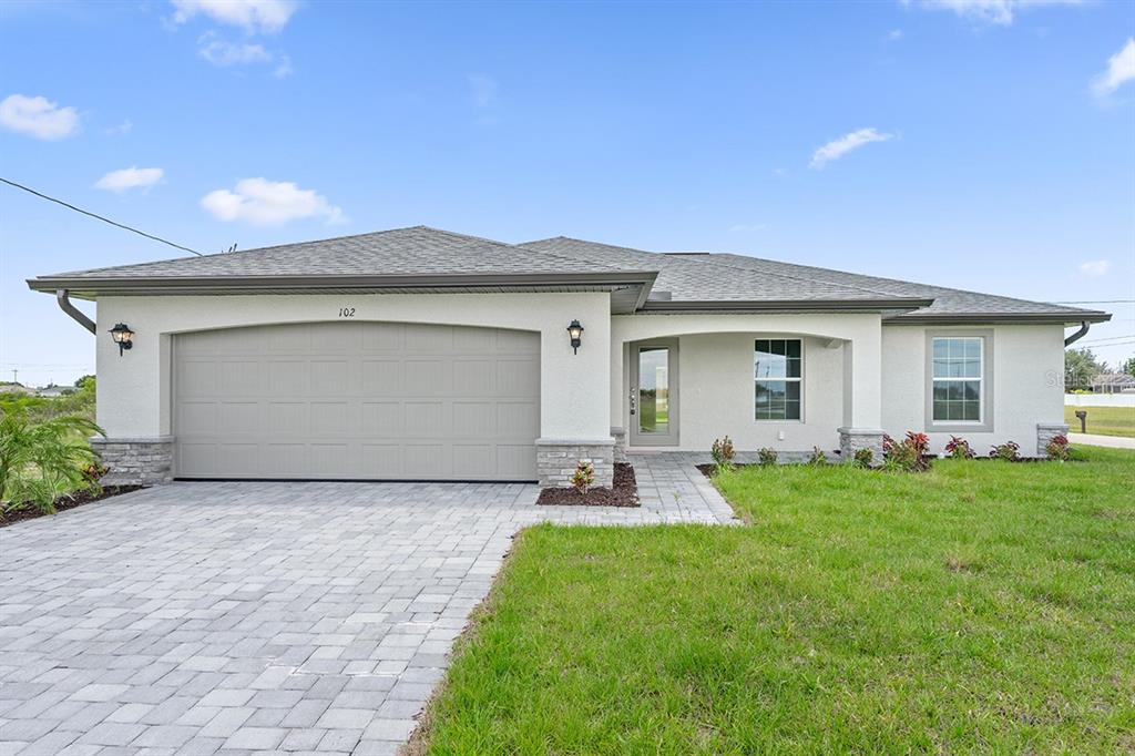 23017 Rye Avenue Port Charlotte, FL 33980 - Photo 1 of 1 a backyard of a house with table and chairs