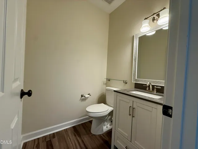 a view of a hallway view with wooden floor and furniture