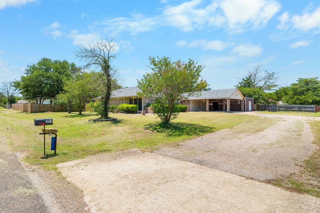 373 Ingred Street Waco, TX 76705 - Photo 21 of 39 a view of a yard with plants and a tree