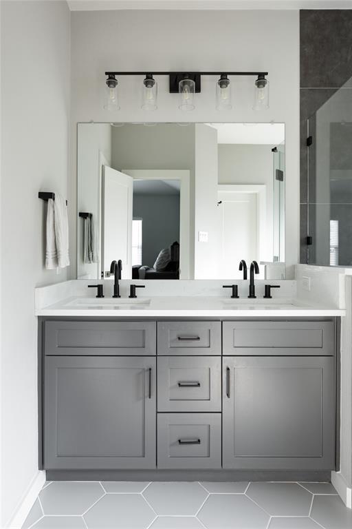 1108 Claude Street Dallas, TX 75203 - Photo 12 of 17 Dual sink vanity featuring gray shaker-style cabinetry and matte black hardware